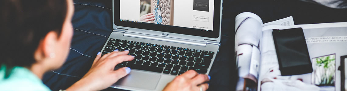 Photo of woman writing a blog post on her laptop